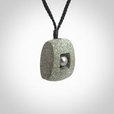 Greywacke stone pendant with Black Pearl insert. Hand carved by Rhys Hall for NZ Pacific. Handmade contemporary jewellery for sale online.